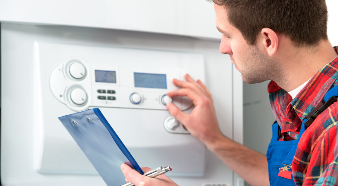 HVAC 911 - heating and air conditioning emergency service and residential maintenance and repairs - Technician Servicing Boiler