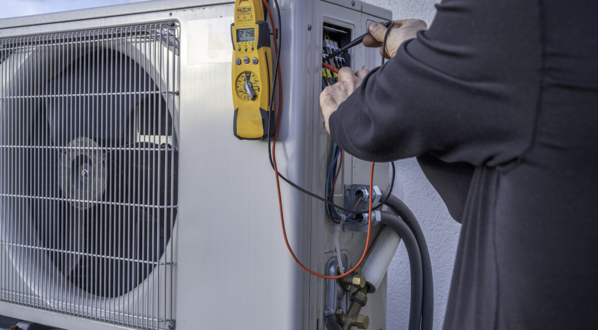 HVAC 911 | HVAC Contractor Referral Service | HVAC Service Tech Repairing A Heat Pump | Heat Pump Repair, Installation, Maintenance